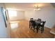 Open floor plan with hardwood floors, a dining table with chairs, and window providing natural light at 4120 N 78Th St # 116, Scottsdale, AZ 85251