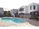 Resort style community pool with mature landscape, stairs to upper level and an outdoor kitchen for entertaining at 4120 N 78Th St # 116, Scottsdale, AZ 85251