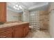 Bathroom features a glass block shower, wood-style vanity, and granite countertops at 4226 N 69Th Pl, Scottsdale, AZ 85251