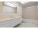 Bathroom with white cabinets and countertops with a large mirror and shower at 4226 N 69Th Pl, Scottsdale, AZ 85251