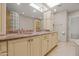 Bathroom with double sinks, a glass block shower, marble countertops, and white cabinets at 4226 N 69Th Pl, Scottsdale, AZ 85251
