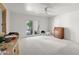 Spacious bedroom with bright natural light, a ceiling fan, and a sliding glass door leading outside at 4226 N 69Th Pl, Scottsdale, AZ 85251
