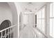 Upstairs hallway featuring modern railing, white walls, and white shutters at 4226 N 69Th Pl, Scottsdale, AZ 85251