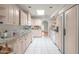 Bright kitchen featuring ample cabinetry, white appliances, and a skylight at 4226 N 69Th Pl, Scottsdale, AZ 85251