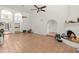 Expansive living room with tile flooring, arched doorways, and a cozy fireplace at 4226 N 69Th Pl, Scottsdale, AZ 85251