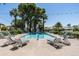 Community pool with lounge chairs and mature landscaping at 4226 N 69Th Pl, Scottsdale, AZ 85251