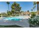 Sparkling pool with ample lounge space and a covered patio is surrounded by lush landscaping at 4226 N 69Th Pl, Scottsdale, AZ 85251