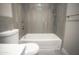 Bathroom showcasing stylish gray tiling and a shower with modern fixtures at 4255 N 68Th Dr, Phoenix, AZ 85033