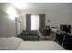 The bedroom features neutral decor, including a futon and an ergonomic office chair at 4255 N 68Th Dr, Phoenix, AZ 85033