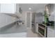 Galley kitchen featuring stainless steel appliances, white cabinets, and gray countertops at 4255 N 68Th Dr, Phoenix, AZ 85033