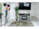 Bright living area features gray flooring, a large TV, and adjacent at-home exercise area at 4255 N 68Th Dr, Phoenix, AZ 85033