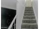 Carpeted stairs lead to the upper level of the home, offering a safe and comfortable transition at 4255 N 68Th Dr, Phoenix, AZ 85033