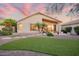 Lovely backyard with artificial turf, palm trees, a covered patio, and rock landscaping at 4462 E Dale Ln, Cave Creek, AZ 85331