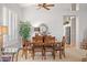 Dining room with wooden table, modern light fixture, and view into kitchen area at 4462 E Dale Ln, Cave Creek, AZ 85331