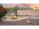 Cozy fire pit area with patio seating, desert landscaping, and a privacy wall for outdoor relaxation at 4462 E Dale Ln, Cave Creek, AZ 85331