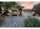 Inviting single-story home with rock landscaping, a two-car garage, and warm exterior lighting at 4462 E Dale Ln, Cave Creek, AZ 85331