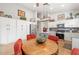 Spacious kitchen has white cabinetry, stainless steel appliances, and a breakfast area with red chairs at 4462 E Dale Ln, Cave Creek, AZ 85331