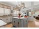 Granite island and breakfast nook in an open-concept kitchen extending into a spacious living area at 4462 E Dale Ln, Cave Creek, AZ 85331