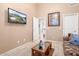 Comfortable living room showing a large TV and access to other rooms at 4462 E Dale Ln, Cave Creek, AZ 85331