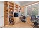 Well-lit home office with custom wooden built-ins and a large window at 4462 E Dale Ln, Cave Creek, AZ 85331
