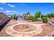 Backyard with a circular walkway and a rustic fire pit providing a cozy outdoor space at 4626 W Altadena Ave, Glendale, AZ 85304