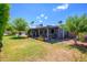 Expansive backyard with a covered patio, mature trees, and verdant lawn at 4626 W Altadena Ave, Glendale, AZ 85304