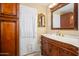 Elegant bathroom with marble countertops, wooden cabinets, and decorative mirror at 4626 W Altadena Ave, Glendale, AZ 85304