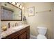 Bathroom features a vanity with marble countertops and a framed mirror at 4626 W Altadena Ave, Glendale, AZ 85304