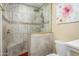 Bathroom featuring tiled walk-in shower with a built-in seat and glass door at 4626 W Altadena Ave, Glendale, AZ 85304