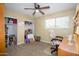 Bright bedroom featuring a ceiling fan and a window providing natural light at 4626 W Altadena Ave, Glendale, AZ 85304