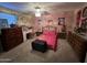 Bedroom features a patterned bedspread, wood furniture, ceiling fan with light kit, and neutral carpet at 4626 W Altadena Ave, Glendale, AZ 85304