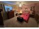 Bedroom boasts patterned bedding, wood furniture, neutral carpet, and a modern ceiling fan with light kit at 4626 W Altadena Ave, Glendale, AZ 85304