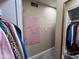 This closet features hanging storage for clothes, a pink pegboard organizer, and neutral walls and carpet at 4626 W Altadena Ave, Glendale, AZ 85304