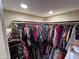 Walk-in closet features extensive built-in shelving and hanging storage, with a wide array of clothing at 4626 W Altadena Ave, Glendale, AZ 85304