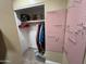 Walk-in closet features organizers, shelving, a variety of clothing, and neutral walls and carpet at 4626 W Altadena Ave, Glendale, AZ 85304