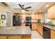 Open kitchen with stainless steel appliances, light wood cabinets and granite countertops at 4626 W Altadena Ave, Glendale, AZ 85304