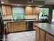 Kitchen with wood cabinets, stainless steel appliances, and a view of the backyard through the window at 4626 W Altadena Ave, Glendale, AZ 85304