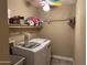 Laundry room featuring a washer and dryer, storage shelves, and ample space at 4626 W Altadena Ave, Glendale, AZ 85304