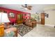 Cozy living room with tile floors, ceiling fan and eclectic decor on a featured red accent wall at 4626 W Altadena Ave, Glendale, AZ 85304