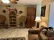 Comfortable living space with a rattan chair, storage cabinet, and tile flooring at 4626 W Altadena Ave, Glendale, AZ 85304