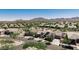 Expansive aerial view of a suburban neighborhood with desert landscaping and mountain views at 4898 N 206Th Ln, Buckeye, AZ 85396