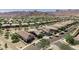 An aerial view captures a desert community nestled beneath the mountains with diverse home styles and desert landscaping at 4898 N 206Th Ln, Buckeye, AZ 85396