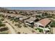 Scenic aerial showcases desert homes with inviting backyards, surrounded by natural desert landscape and mountain backdrop at 4898 N 206Th Ln, Buckeye, AZ 85396