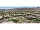 Wide aerial shot of a neighborhood featuring lush trees and mountain views at 4898 N 206Th Ln, Buckeye, AZ 85396