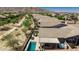 This aerial showcases a backyard oasis with pool, spa, covered patio and lounge seating at 4898 N 206Th Ln, Buckeye, AZ 85396