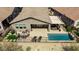 Aerial shot showcasing backyard with pool, patio dining, lounge seating and well-manicured landscape at 4898 N 206Th Ln, Buckeye, AZ 85396