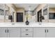 Bathroom with dual vanity sinks, framed mirrors, and ample counter space at 4898 N 206Th Ln, Buckeye, AZ 85396