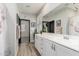 Bathroom with a double sink vanity, drawers, and a large mirror at 4898 N 206Th Ln, Buckeye, AZ 85396