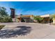 Exterior view of the clubhouse with a modern desert design and ample parking at 4898 N 206Th Ln, Buckeye, AZ 85396
