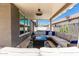 Relaxing covered patio with comfortable seating, a ceiling fan, and stylish decor, perfect for outdoor lounging at 4898 N 206Th Ln, Buckeye, AZ 85396
